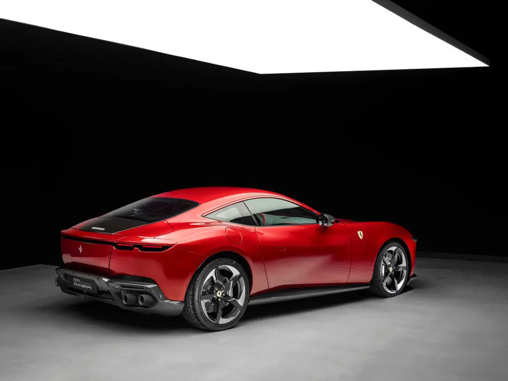 Rear three-quarter view — sculpted shoulders and a full-width light bar give the Amalfi an architectural presence at night. Photo: Ferrari.